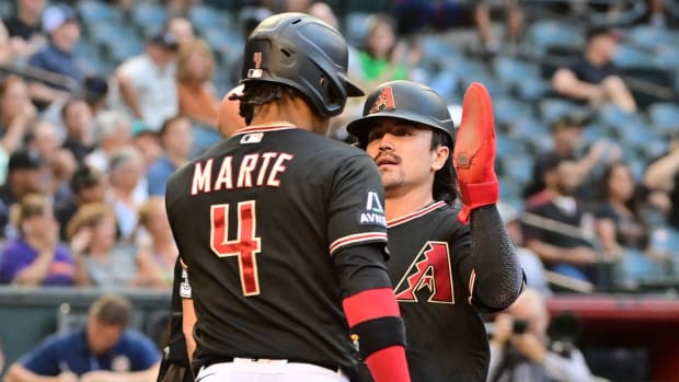 Corbin Carroll (7) celebrates with Ketel Marte (4) at home plate after both players scored on Lourdes Gurriel Jr.s